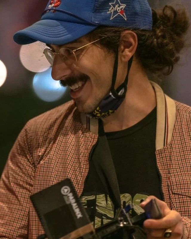 Nick Belotti, video partner, on set with a camera in hand